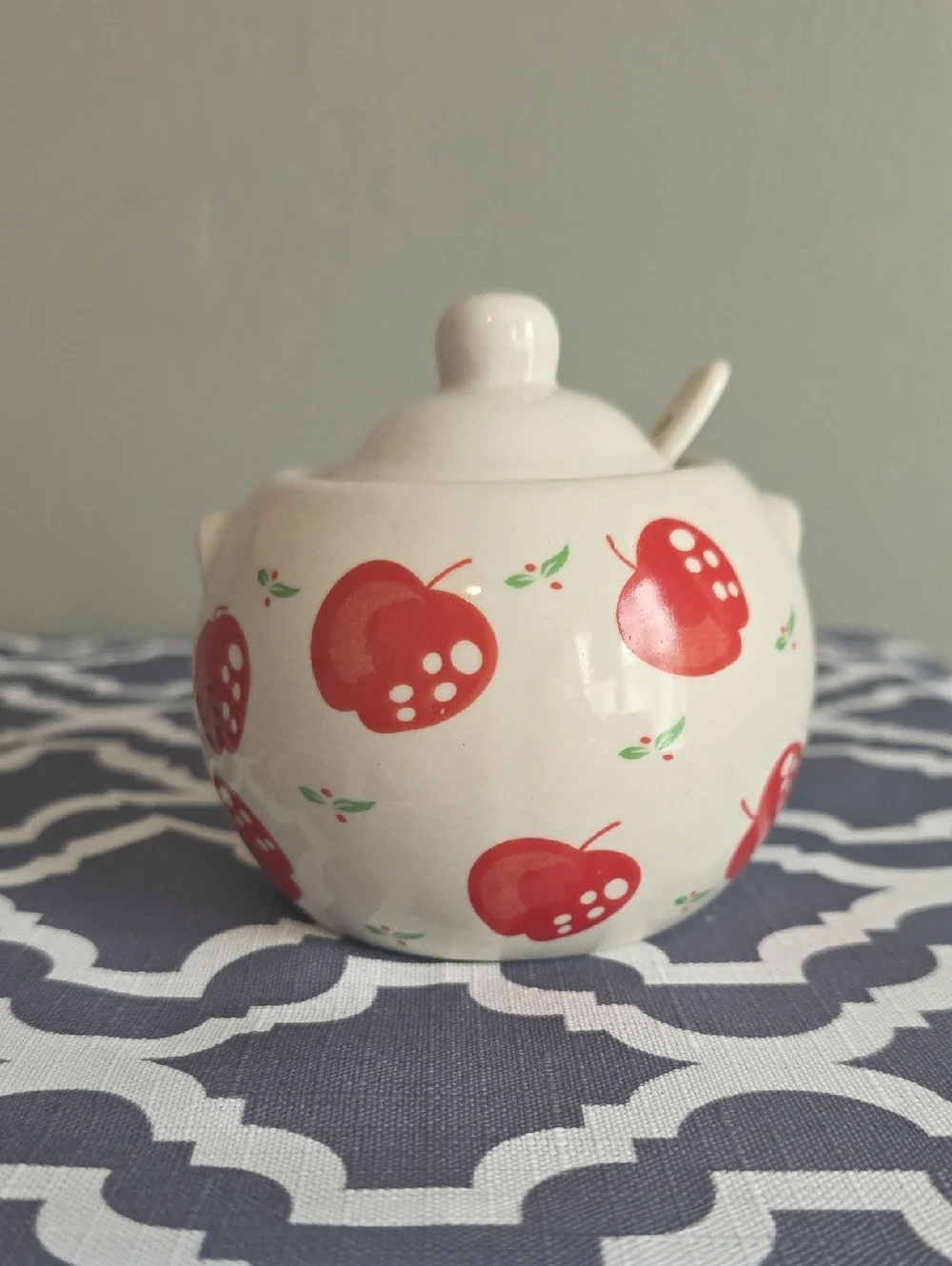 White Ceramic Sugar Jar with Red Apple Motif and Spoon